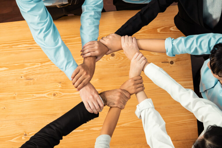 Multicultural business people holding hand together in circle